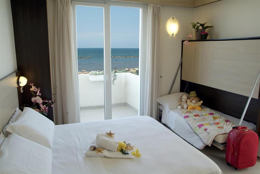 Postel nebo postele na pokoji v ubytování Hotel Universal