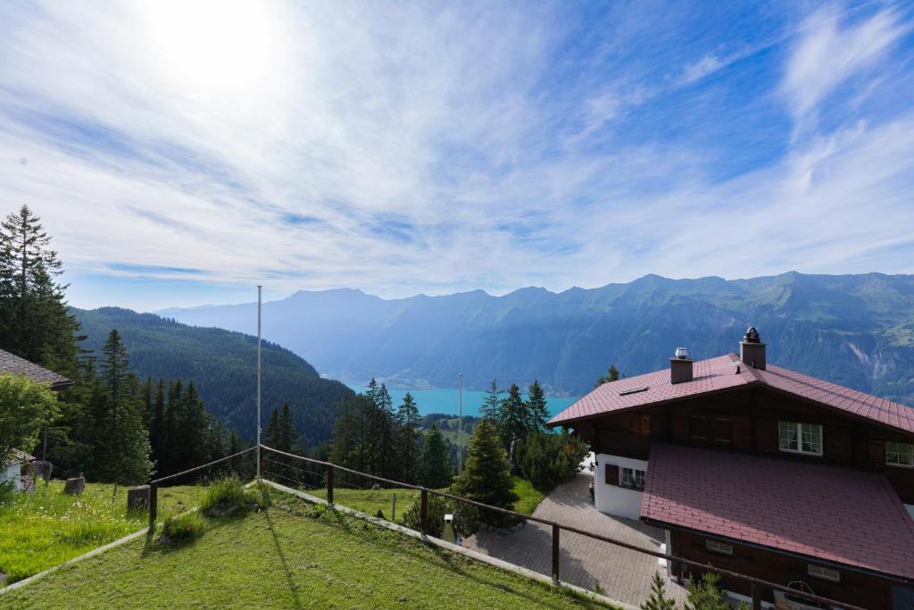 a house on a hill with a view of the mountains at Chalet Chutzli in Axalp