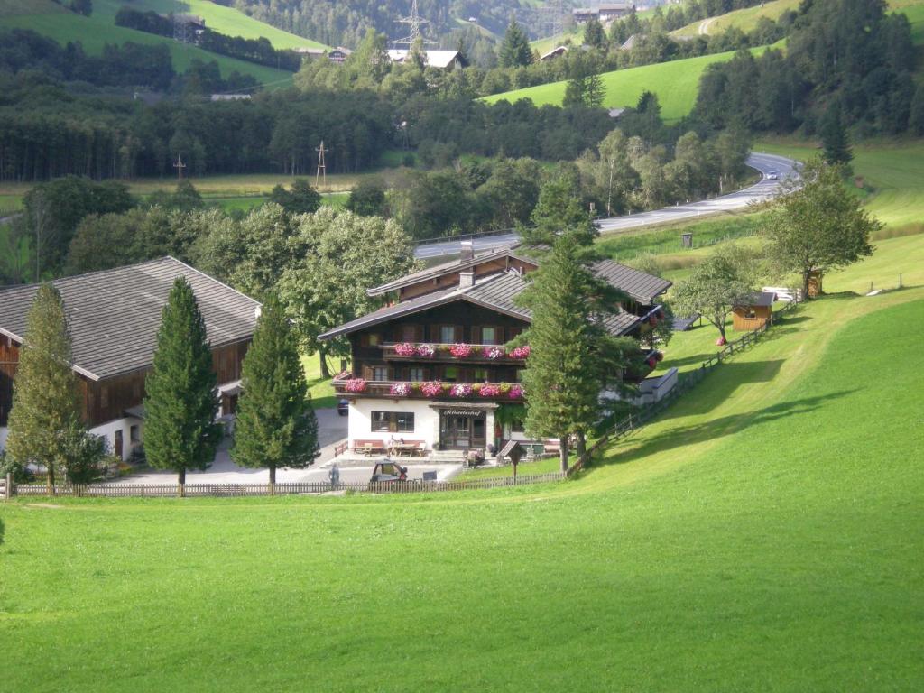 an aerial view of a house in a green field at Schiederhof in Mittersill