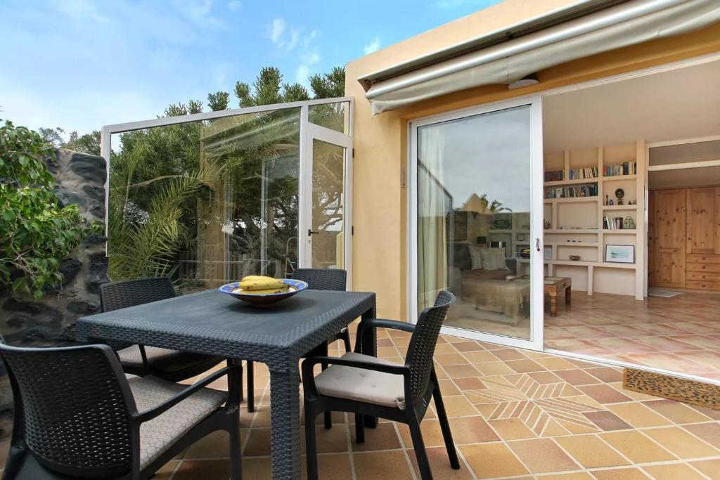 a dining table and chairs on a patio at Casa Verde in Teguise