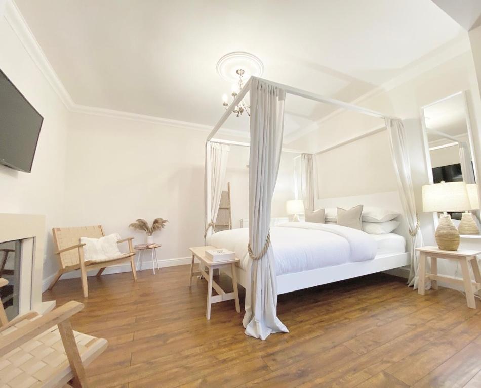 a bedroom with a white bed with a canopy at Queens stay, Seaburn in Sunderland