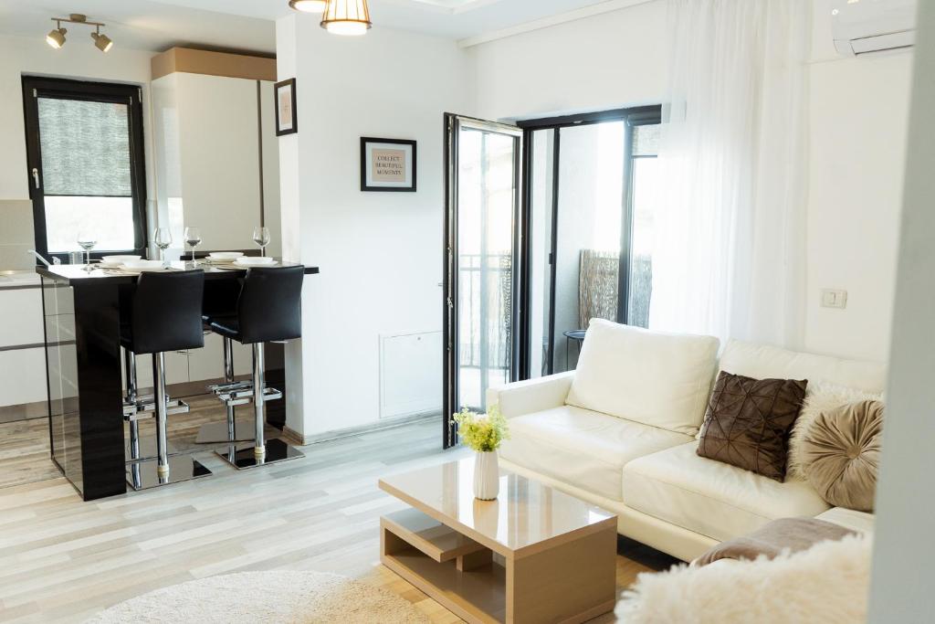 a living room with a couch and a table at Luxury Apartment with Private Parking in Giroc