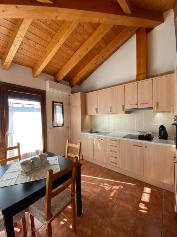 a kitchen with a table and a dining room at Dúplex Teresa in Alcañiz