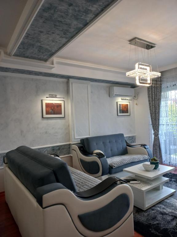 a living room with couches and a table at Twins Apartments in Čačak