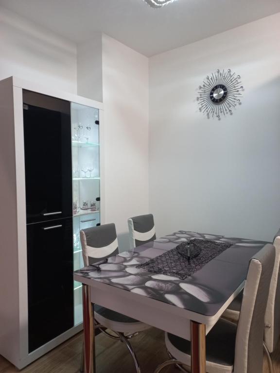 a dining room with a table and chairs at Twins Apartments in Čačak