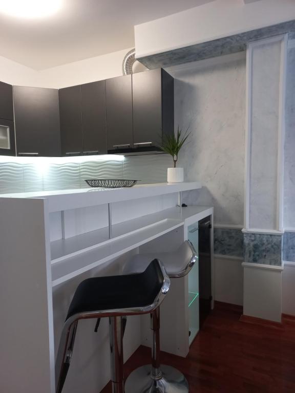 a kitchen with a desk and a chair at Twins Apartments in Čačak