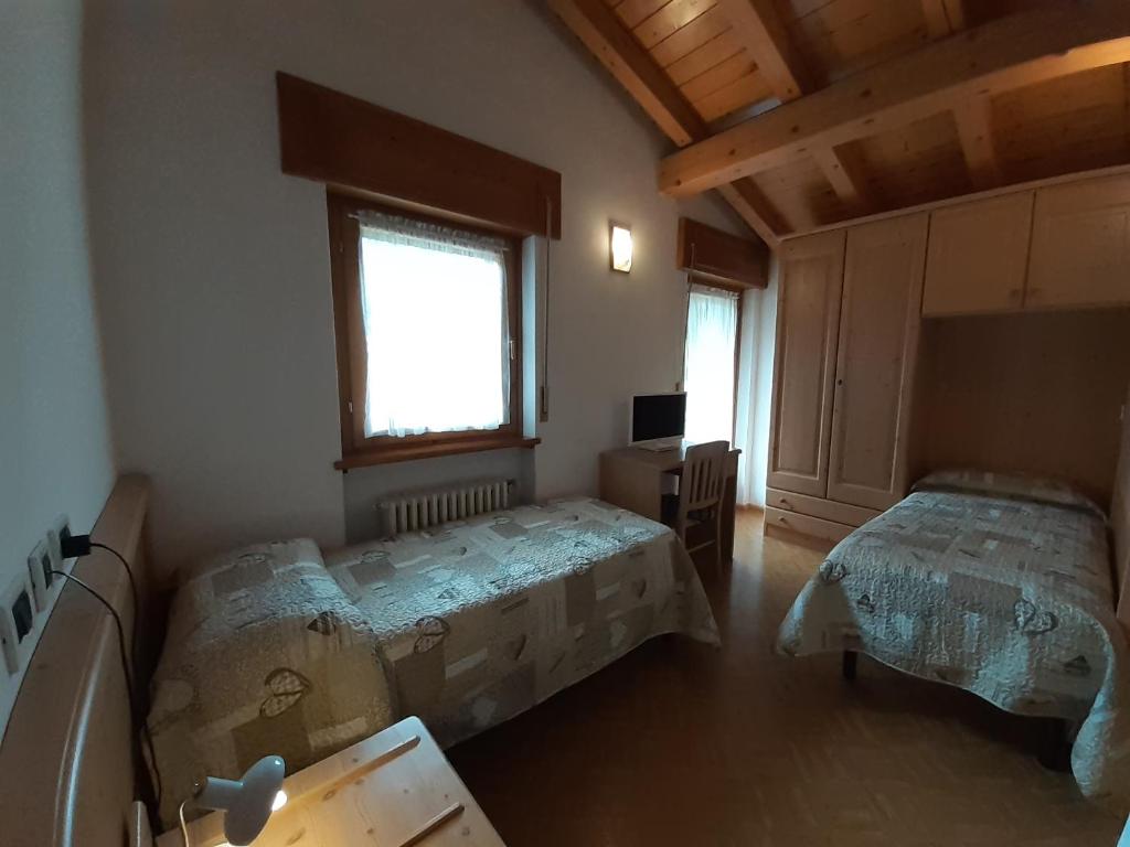 Postel nebo postele na pokoji v ubytování Hotel Garnì Miramonti