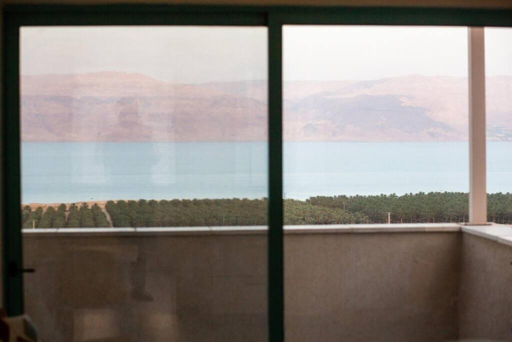 a view of the water from a window at family apartment Dead-sea view in Ovnat