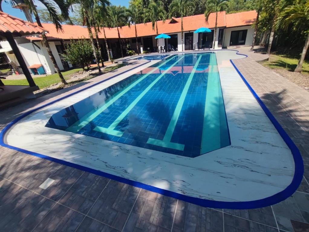 a swimming pool with blue water in a resort at Casa Montenegro in Villavicencio