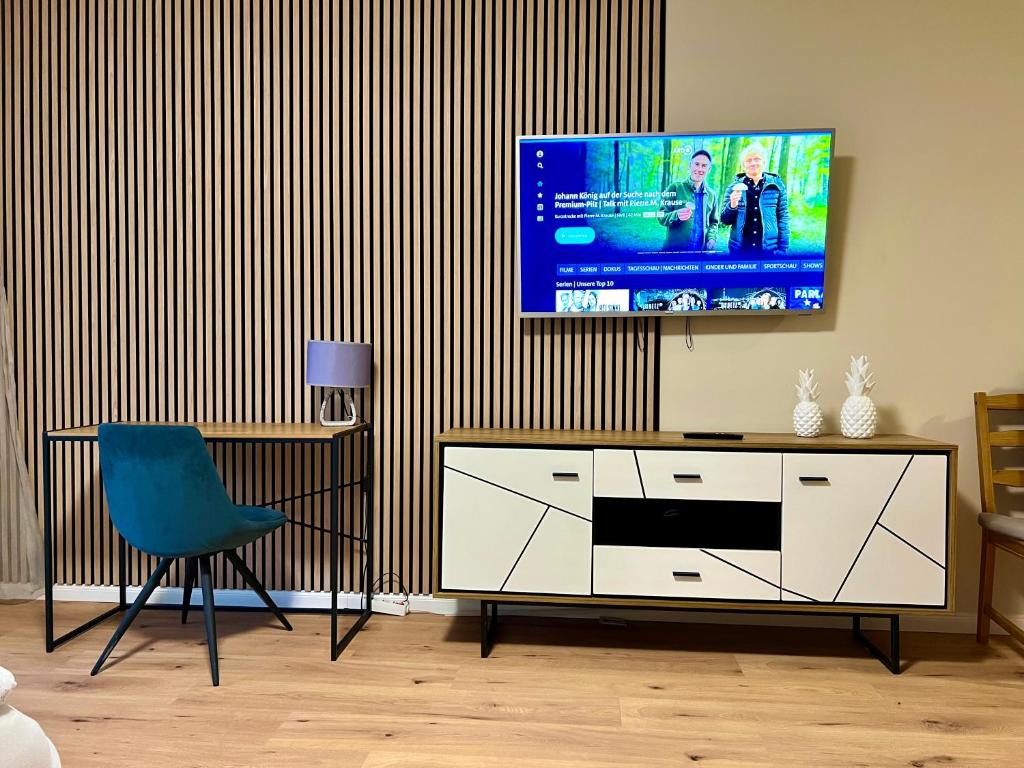 a living room with a television on a wall at Apartment Beethoven by Aux Property in Augsburg