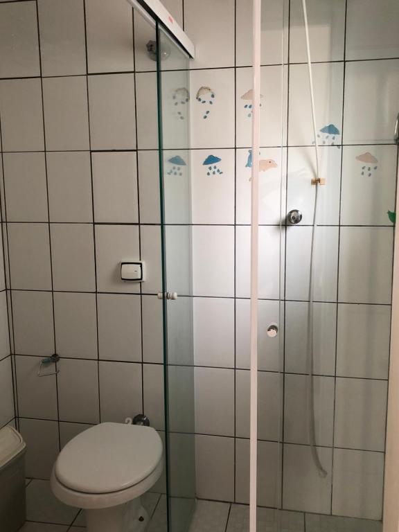 a bathroom with a toilet and a shower at Relax Pitangueiras Guarujá in Guarujá