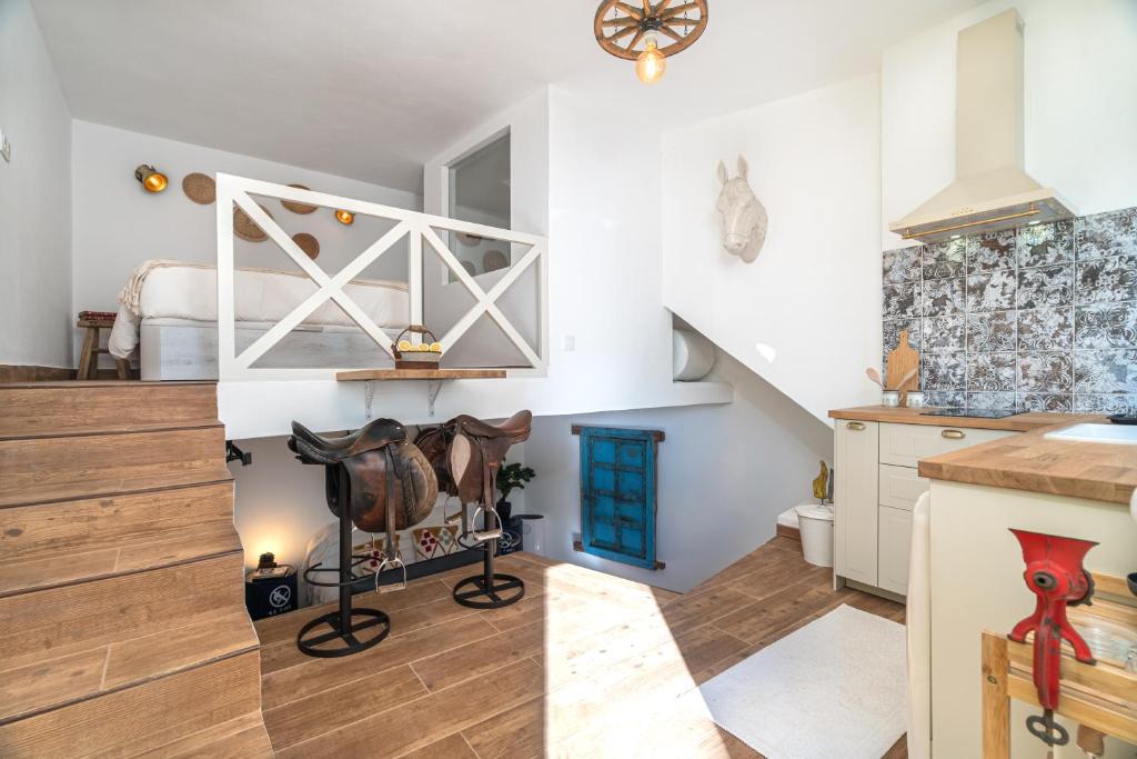 a room with a staircase and a bedroom with a bed at Casa Estábulo- Cozy Rustic Farmhouse (HORSE LOFT) in Estômbar
