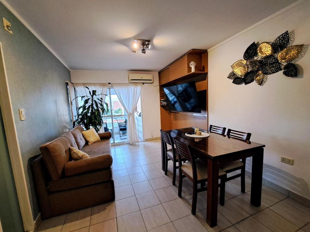 uma sala de estar com um sofá e uma mesa de jantar em Paraná Confort em Paraná