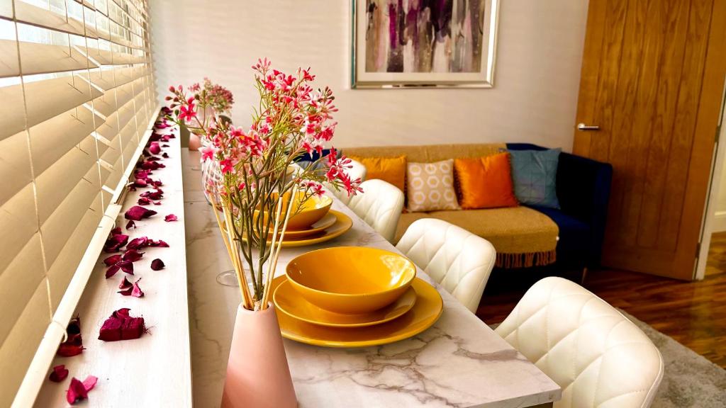 a living room with a table with flowers on it at Market Street Casa by KP in Nottingham