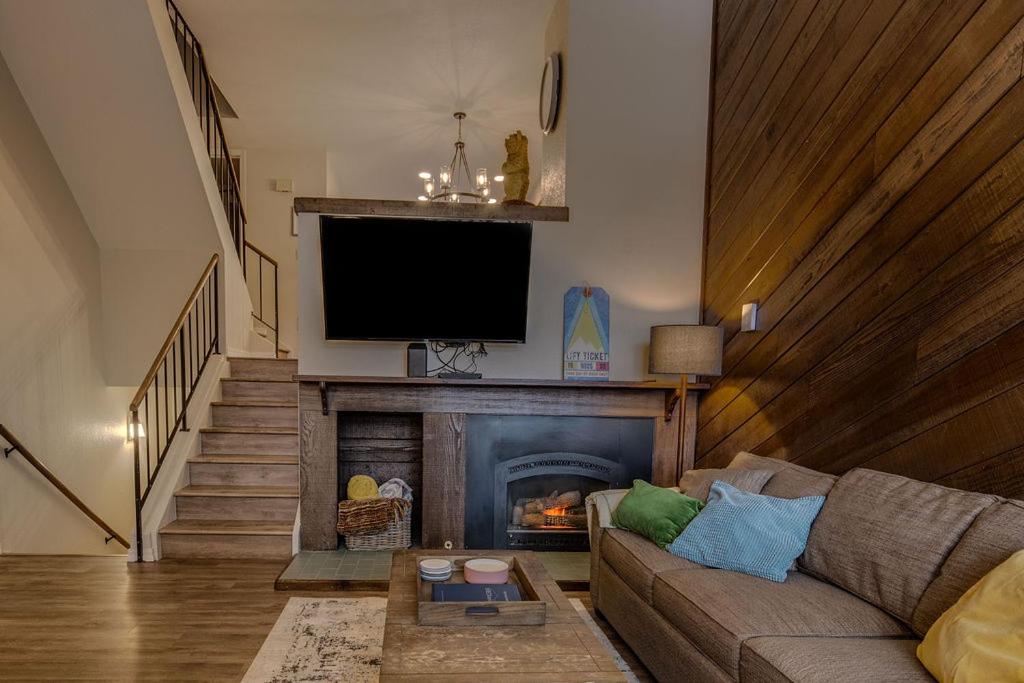 a living room with a couch and a fireplace at Townhome Four O'Clock in Breckenridge