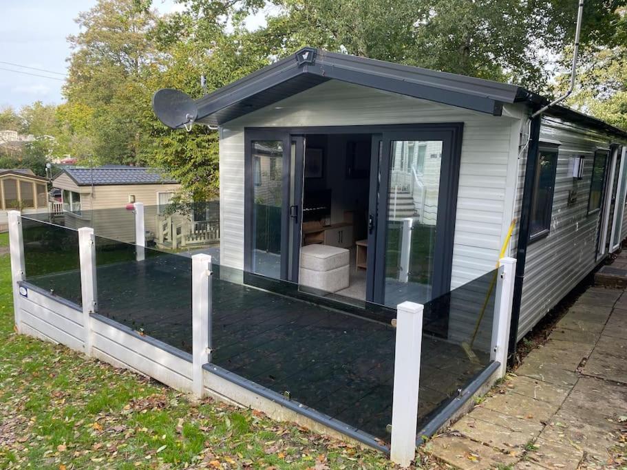 a screened in porch of a tiny house at Coghurst Hall Holiday Home Sleeps 6, 2 bedrooms in Hastings