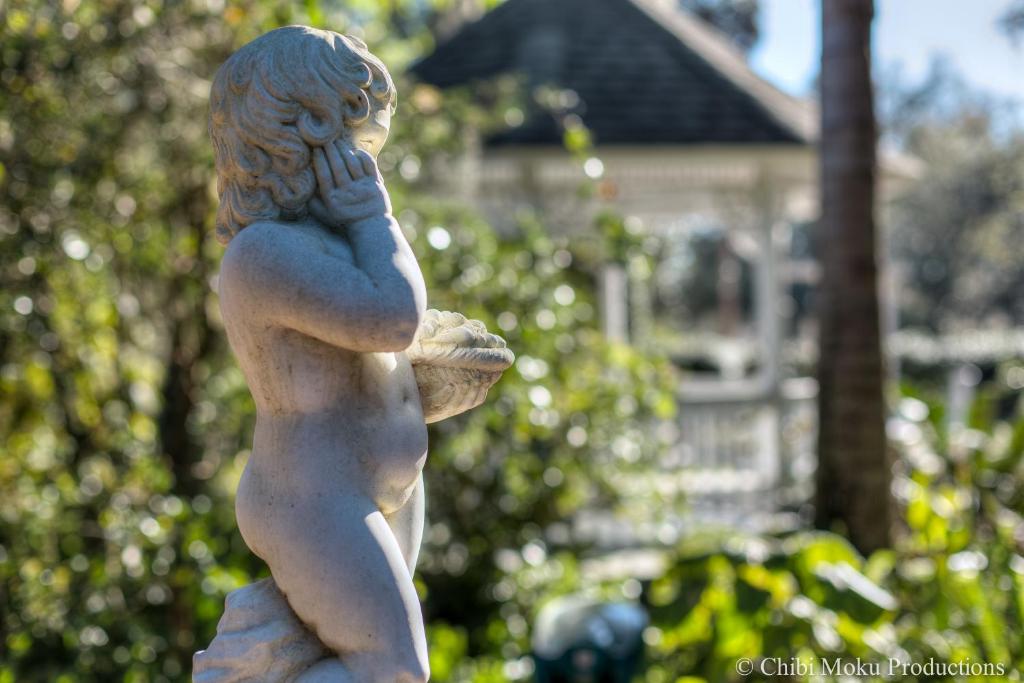 a statue of a little girl holding a shell at Sweetwater Branch Inn in Gainesville