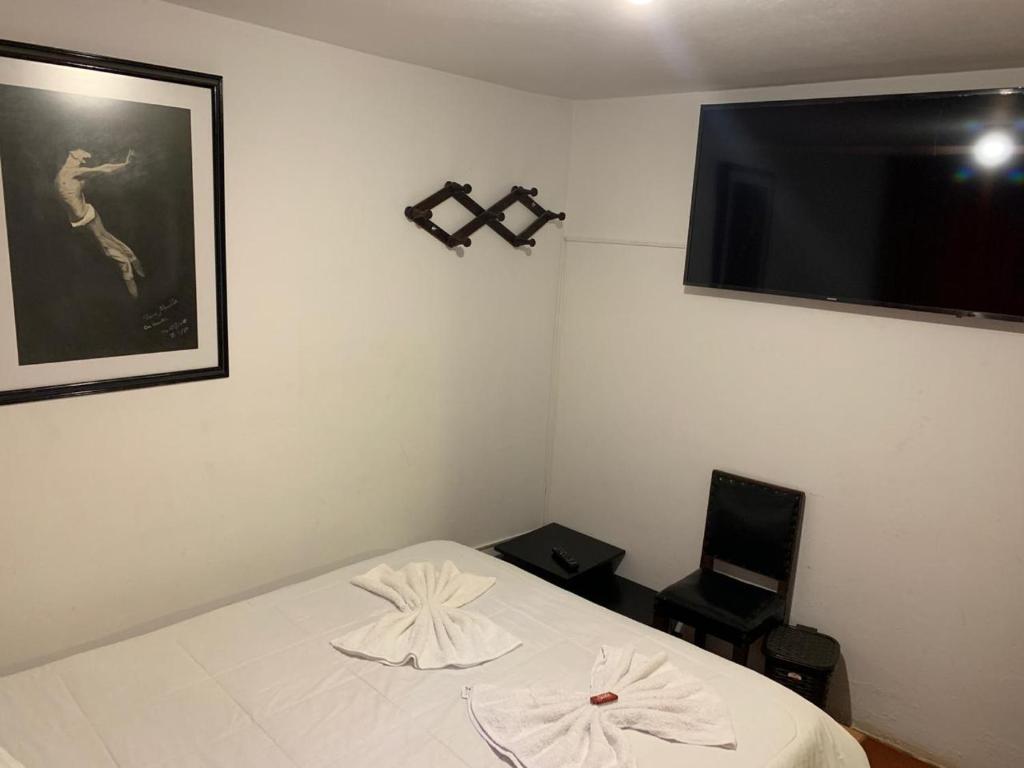 Postel nebo postele na pokoji v ubytování Hostal Home Sant Angelo