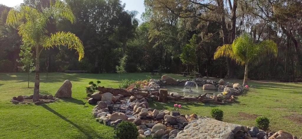 a herd of sheep in a park with a fountain at CABAÑAS LOS LAURELES in Huasca de Ocampo