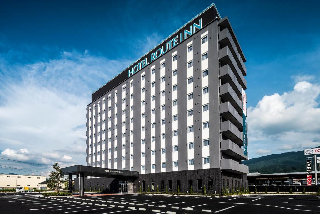 un edificio de hotel con un cartel en el costado en Hotel Route Inn Shikoku Chuo, en Shikokuchuo