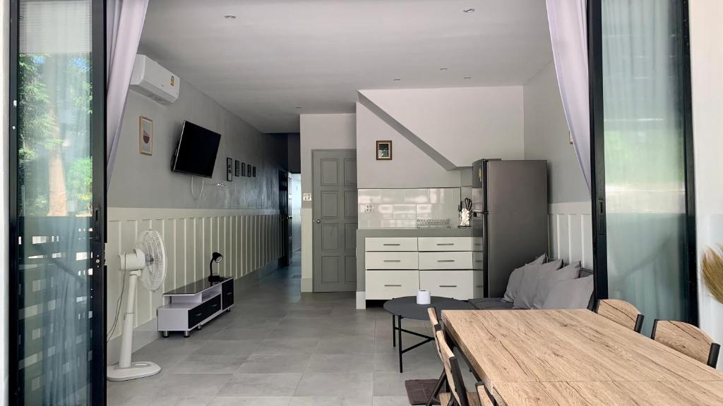 a kitchen with a table and a dining room at Island House Rentals 25 in Ko Samed