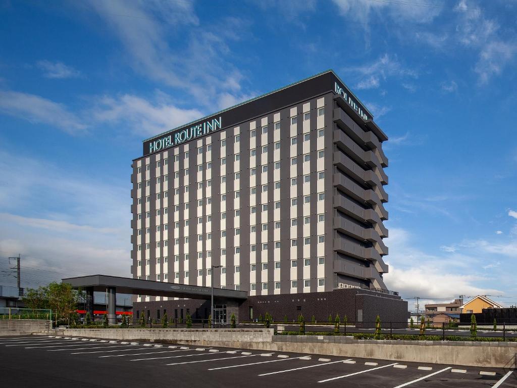 a hotel building with a sign on the side of it at Hotel Route Inn Shunan - Tokuyama Higashi Inter - in Shunan