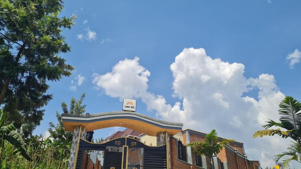 a building with a sign on top of it at CLEMENT MOTEL in Rutsiro