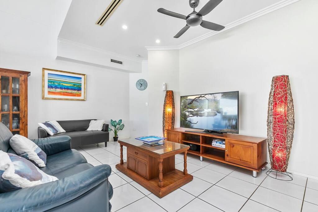 a living room with a couch and a tv at Smooth Sailing -Modern 2 bedroom apartment! in Bellara