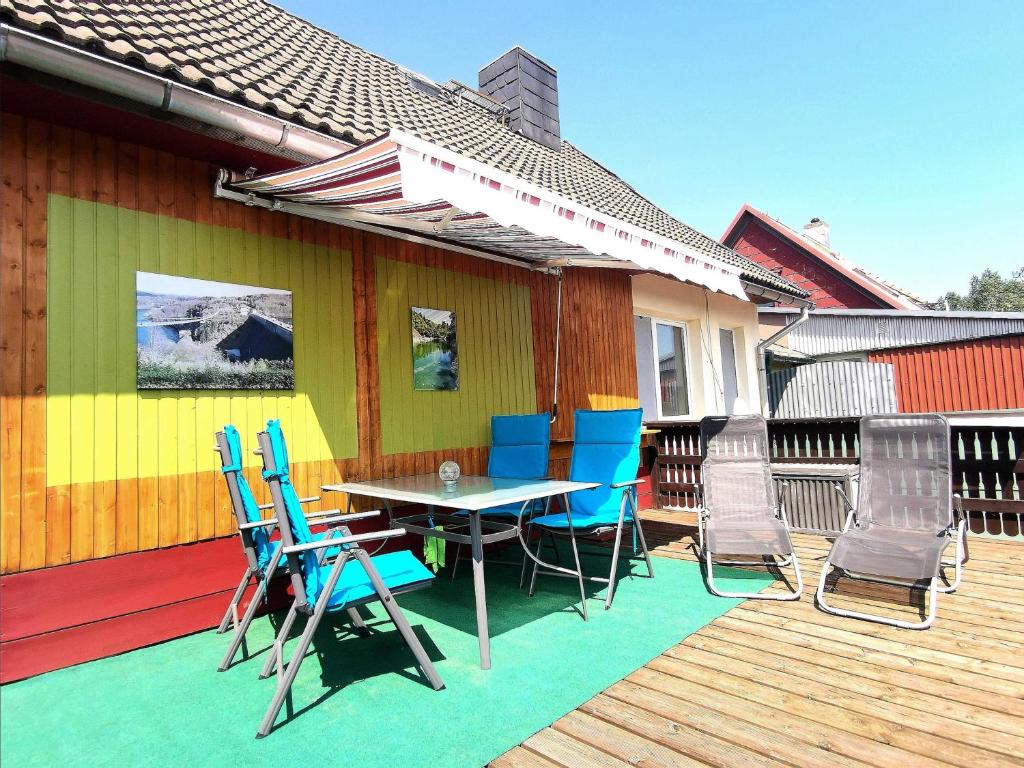 a patio with a table and chairs on a deck at Ferienwohnung Martina in Hasselfelde