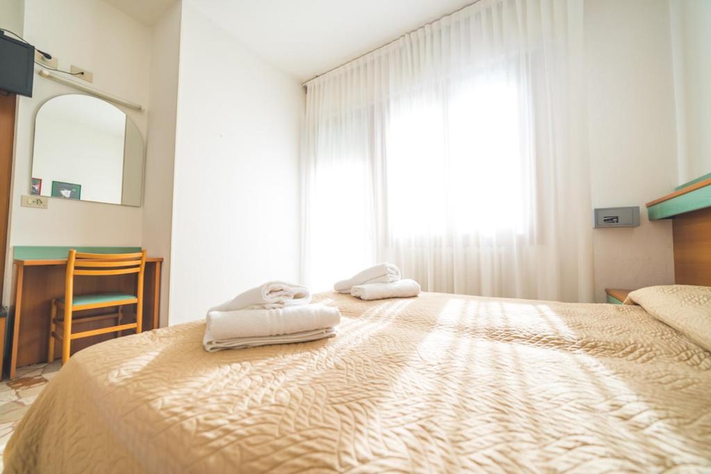 Postel nebo postele na pokoji v ubytování Hotel Grand Prix
