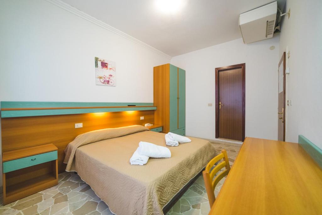 Postel nebo postele na pokoji v ubytování Hotel Grand Prix