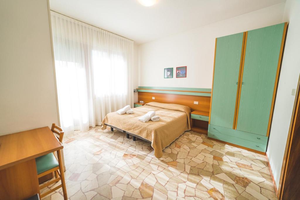 Postel nebo postele na pokoji v ubytování Hotel Grand Prix