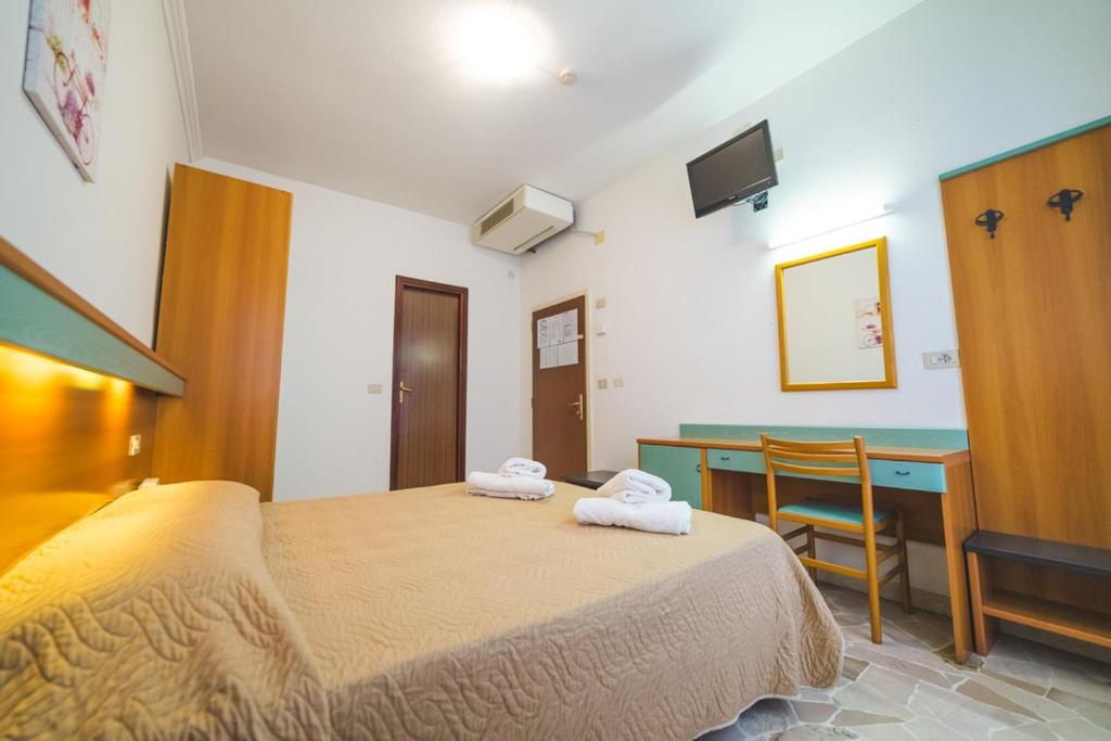 Postel nebo postele na pokoji v ubytování Hotel Grand Prix