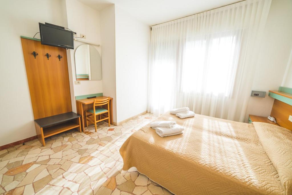 Postel nebo postele na pokoji v ubytování Hotel Grand Prix
