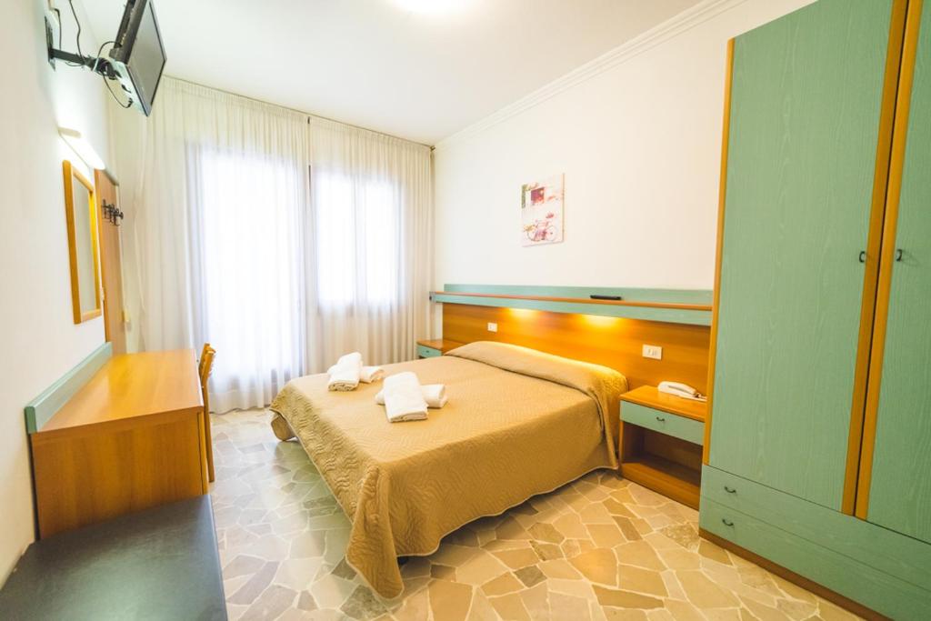 Postel nebo postele na pokoji v ubytování Hotel Grand Prix