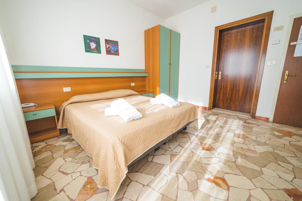 Postel nebo postele na pokoji v ubytování Hotel Grand Prix