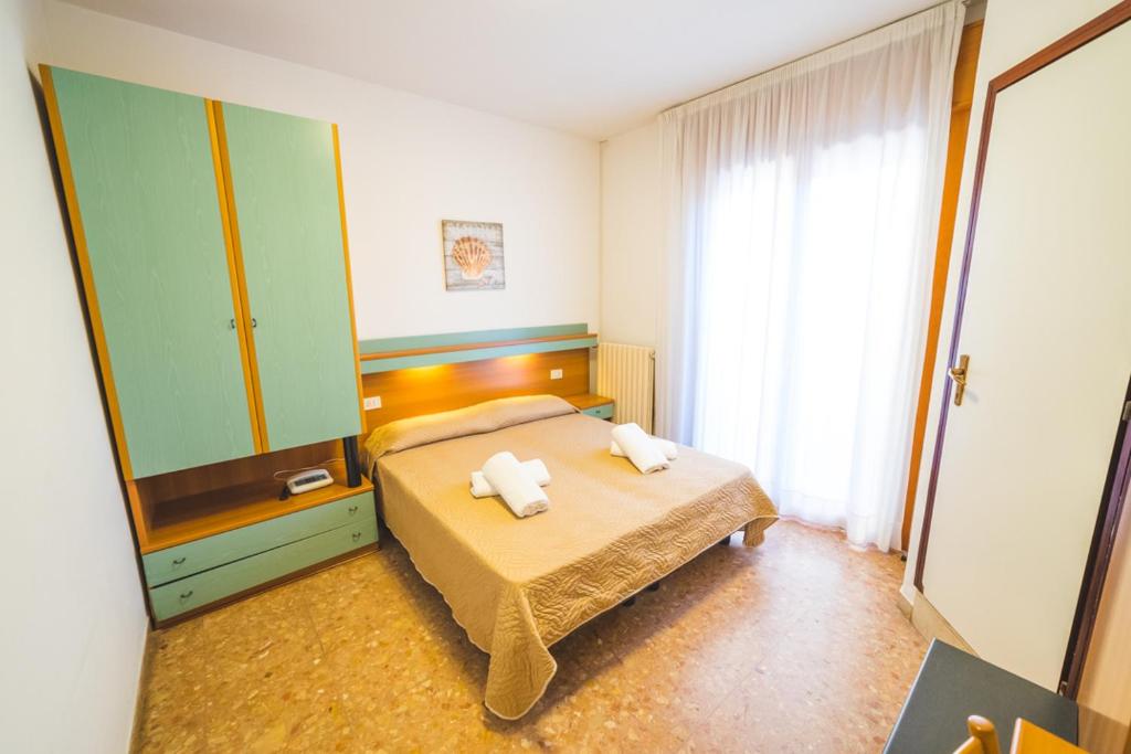 Postel nebo postele na pokoji v ubytování Hotel Grand Prix