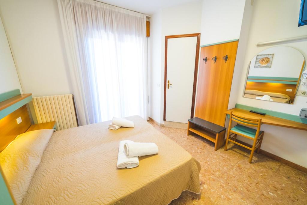 Postel nebo postele na pokoji v ubytování Hotel Grand Prix