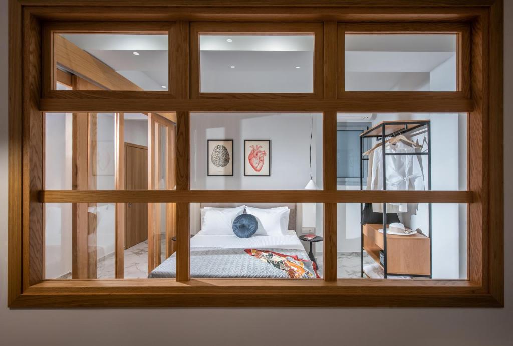 a view of a bedroom through a window at Kipos Boutique Suites in Heraklio