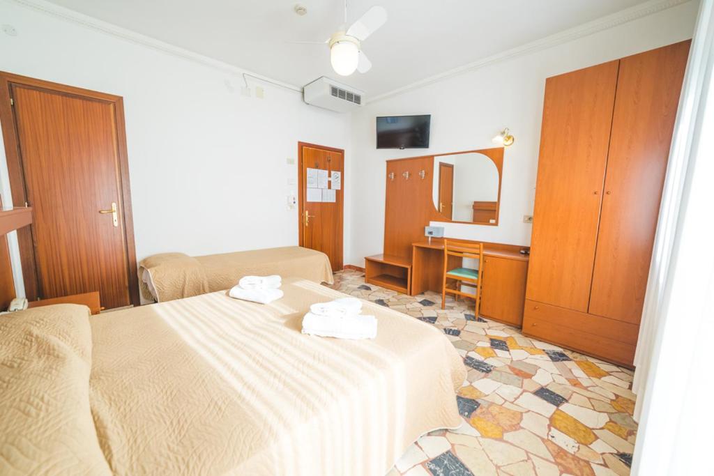 Postel nebo postele na pokoji v ubytování Hotel Grand Prix