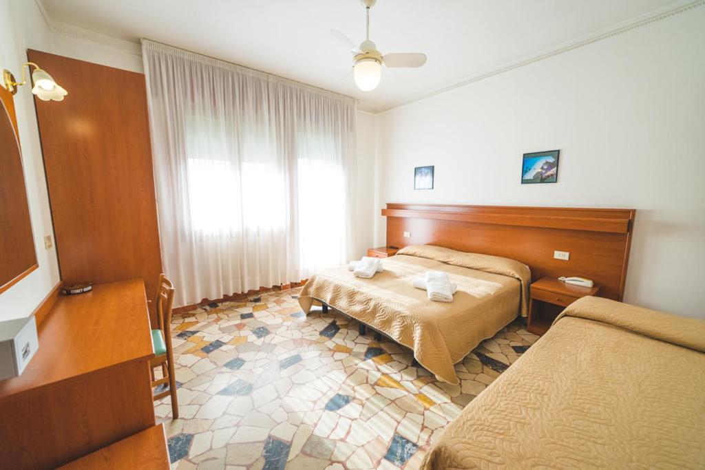 Postel nebo postele na pokoji v ubytování Hotel Grand Prix