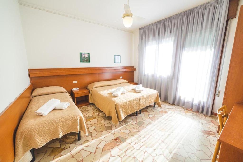 Postel nebo postele na pokoji v ubytování Hotel Grand Prix