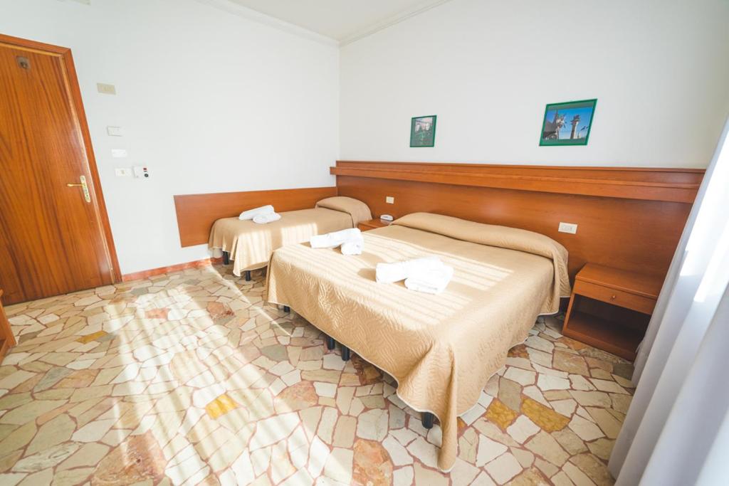 Postel nebo postele na pokoji v ubytování Hotel Grand Prix