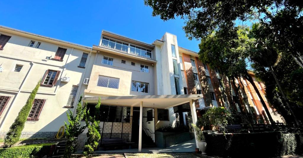 a white building with an awning in front of it at Vila Betânia in Porto Alegre