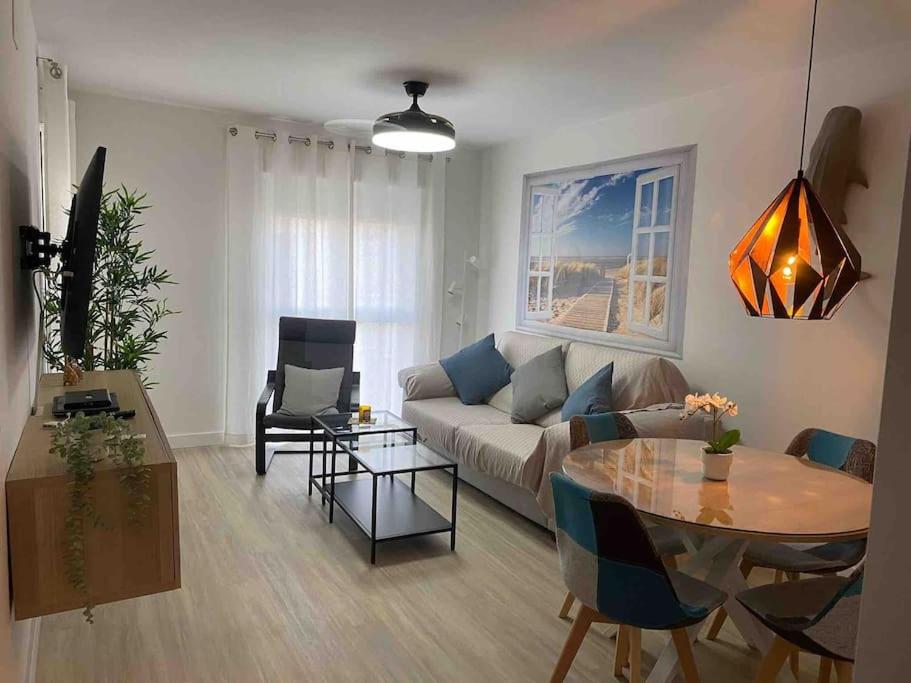 a living room with a couch and a table at Octopus´Garden in La Herradura