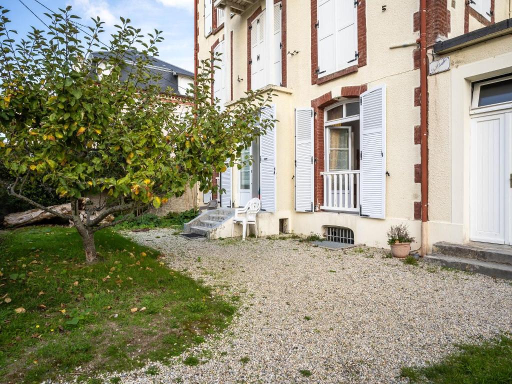 an orange tree in front of a building at Apartment Le Chalet by Interhome in Cabourg