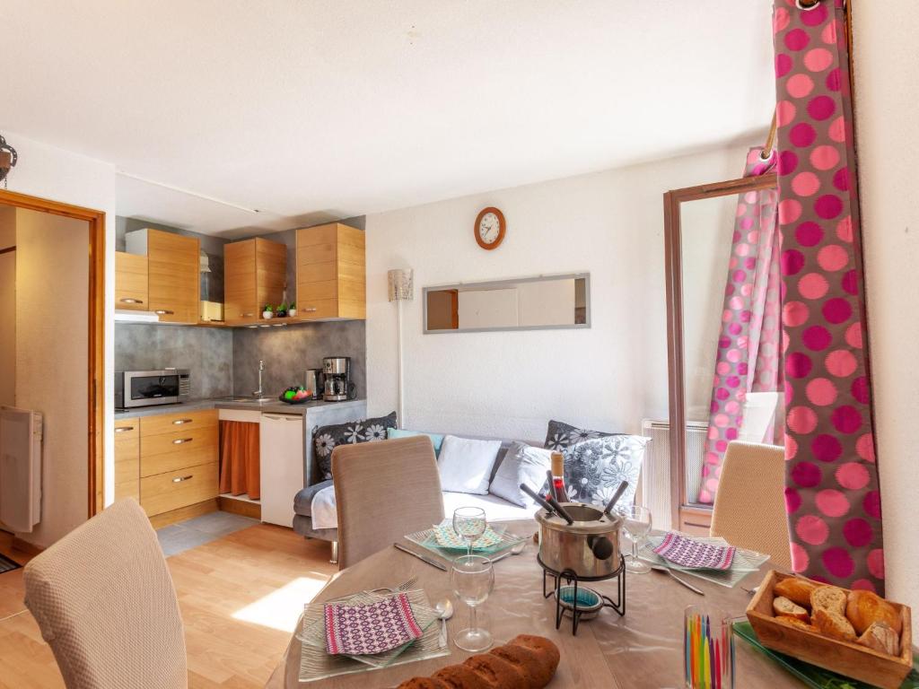 a kitchen and a living room with a dining table at Apartment Le Bochate-5 by Interhome in Saint-Pancrace