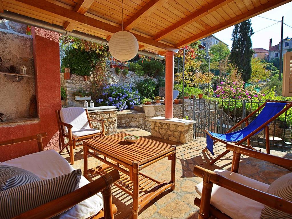 a patio with a hammock and a table and chairs at Holiday Home Mirna by Interhome in Ložišće