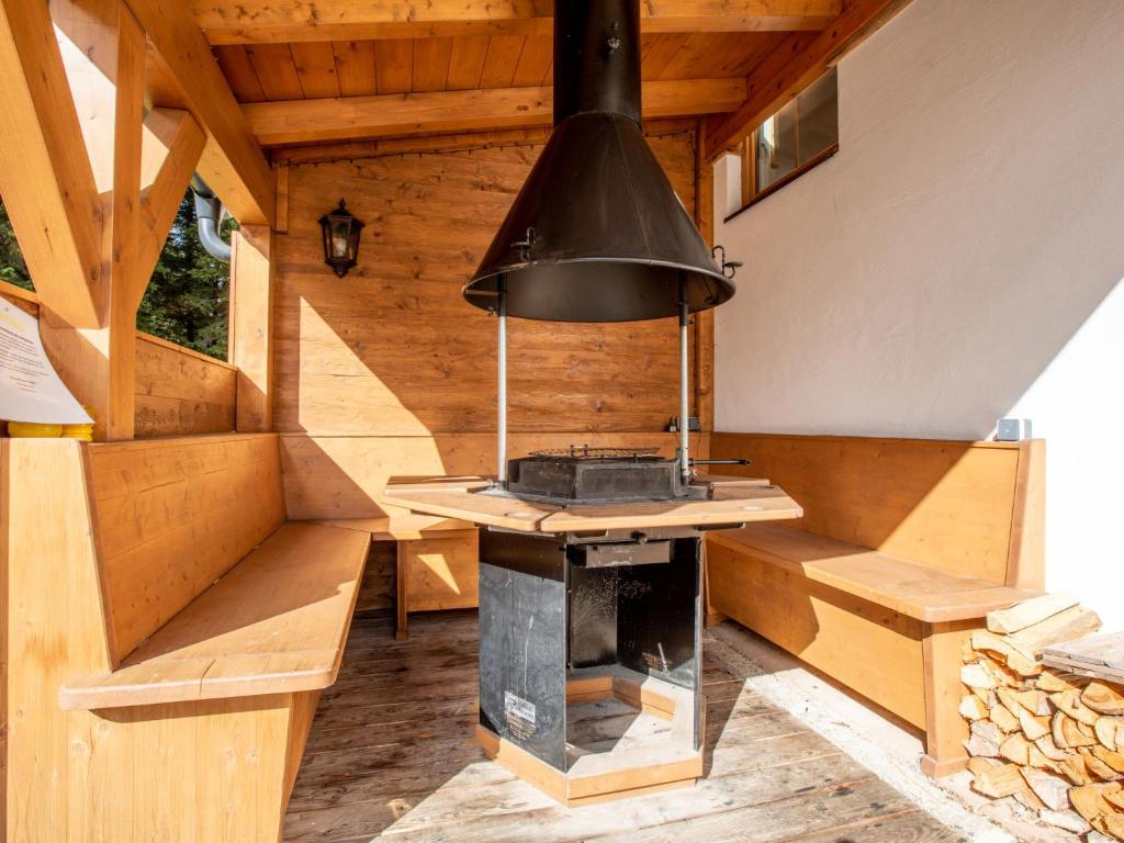 an outdoor kitchen with a stove in a cabin at Chalet Hochkrimml 2 by Interhome in Krimml