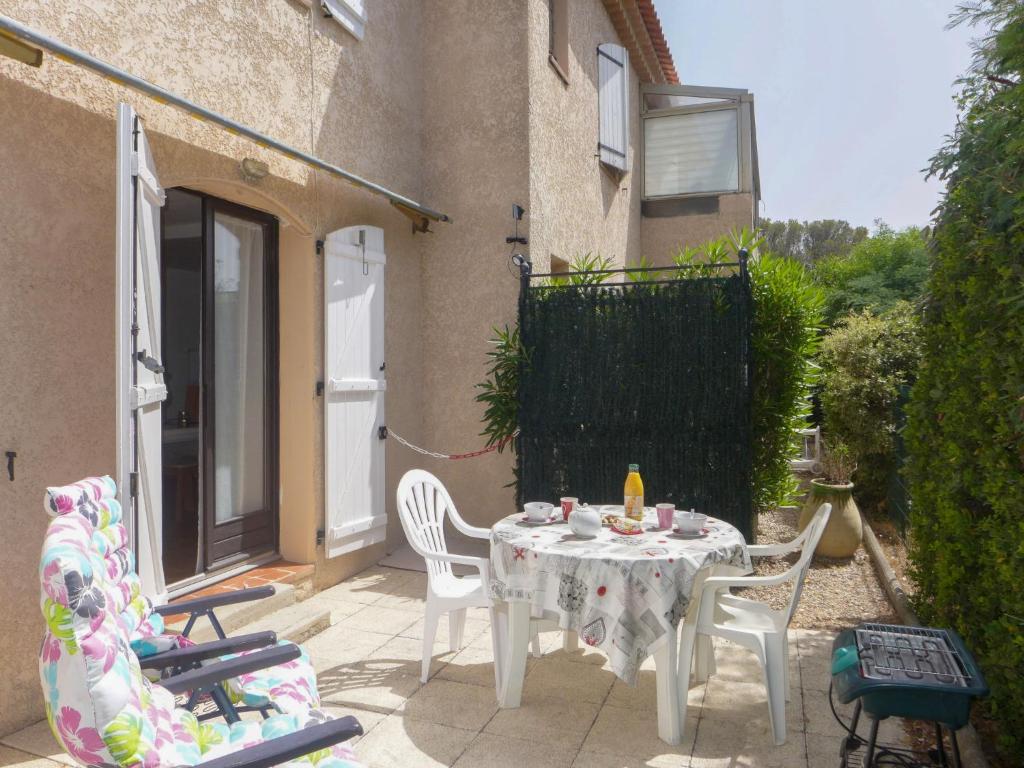 a patio with a table and chairs on a balcony at Apartment Il était une fois-1 by Interhome in Saint-Aygulf